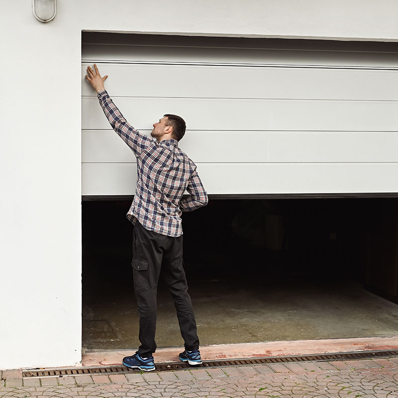 Man lifting door at warehouse